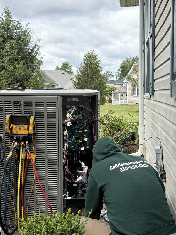 Home rangers technician repairing ac condenser with fieldpiece manifold in philadelphia suburbs