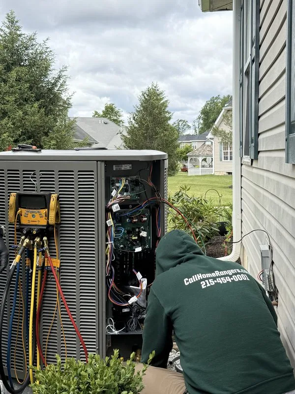 Home rangers technician repairing an outdoor ac condenser during an air conditioning service visit