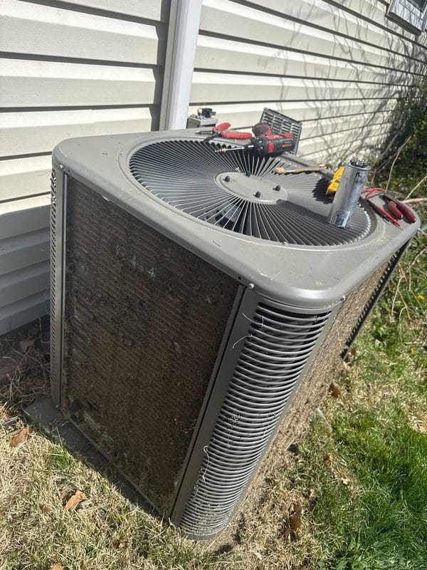 Dirty ac condenser unit with debris needing professional service