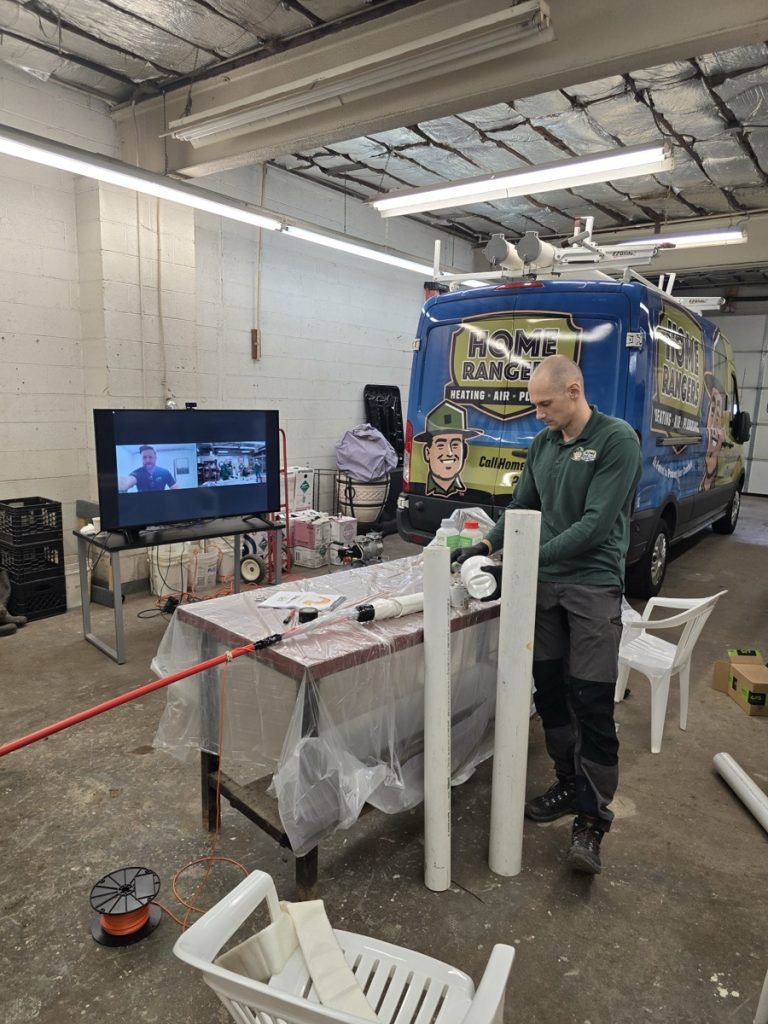 Home rangers technician with trenchless sewer repair training equipment and service van