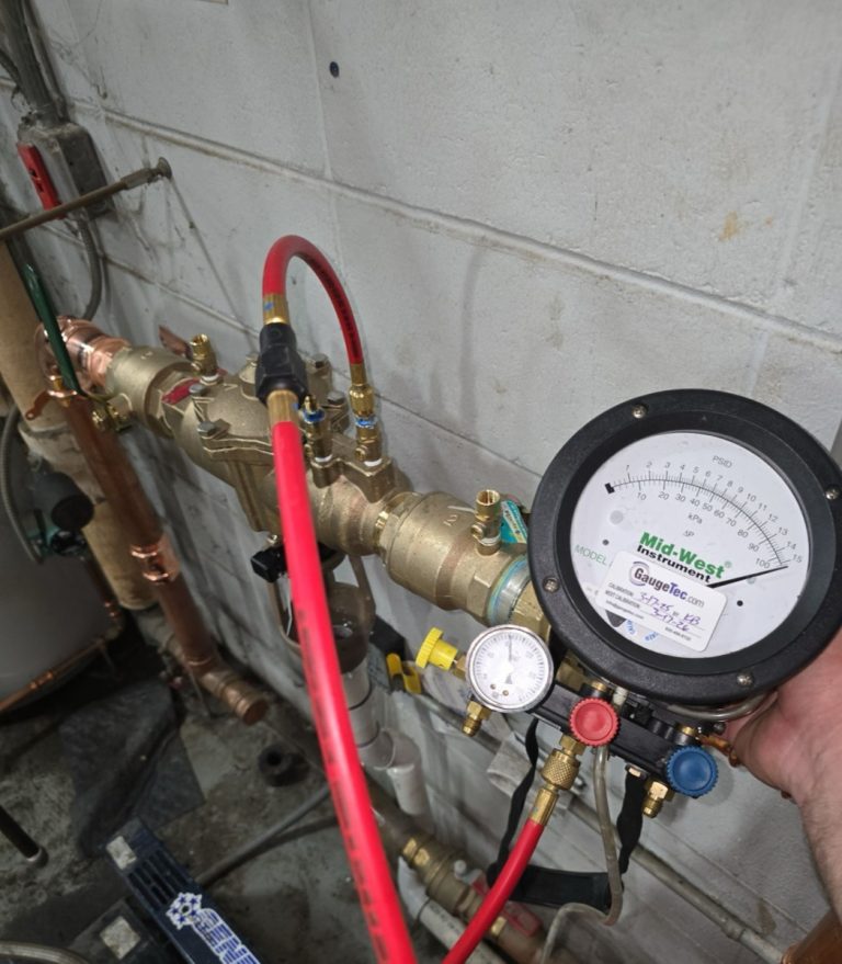 Backflow prevention testing gauge connected to a backflow preventer by home rangers